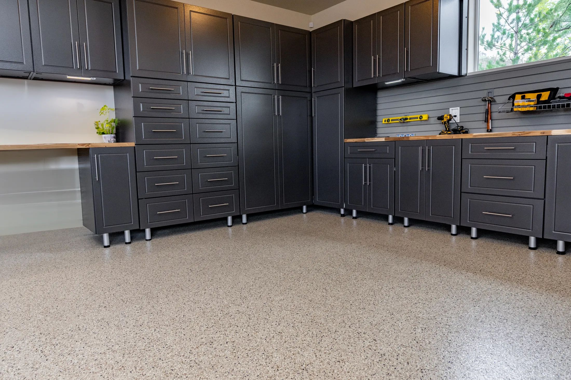 Custom powder coated garage cabinets in black with red doors and precision fit layout